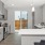Modern kitchen with gray cabinets, white countertops, and stainless steel appliances inside homes at Chapel Creek Cottages