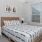 Carpeted bedroom furnished with a bed and two nightstands inside a home at Chapel Creek Cottages