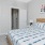 Furnished bedroom with a walk-in closet inside a model unit home at Chapel Creek Cottages