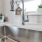 Stainless steel sink underneath a bright window inside a unit kitchen at Chapel Creek Cottages